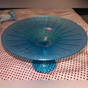 This is a Fenton Celeste Blue Stretch Glass Compote. 
It is an iridescent dish.
